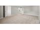 Large bedroom with ensuite bath featuring neutral carpet, walk-in closet, and ample natural light at 6424 Chadwell Ct, Fort Mill, SC 29707