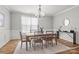 Cozy dining area illuminated by a chandelier, complemented by a large window with sheer curtains at 6424 Chadwell Ct, Fort Mill, SC 29707