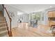 Open concept dining area with hardwood floors seamlessly flowing into the living area and kitchen at 6424 Chadwell Ct, Fort Mill, SC 29707