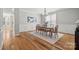 Elegant dining room featuring hardwood floors, wainscoting, chandelier, and ample seating at 6424 Chadwell Ct, Fort Mill, SC 29707
