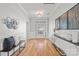 Elegant foyer with hardwood floors, wainscoting, decorative art, and natural light at 6424 Chadwell Ct, Fort Mill, SC 29707