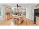 Bright kitchen features a granite island with seating, stainless steel appliances and beautiful wood floors at 6424 Chadwell Ct, Fort Mill, SC 29707