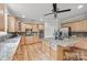 Bright kitchen features a granite island with seating, stainless steel appliances and beautiful wood floors at 6424 Chadwell Ct, Fort Mill, SC 29707