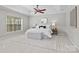 Bright main bedroom featuring natural light, a ceiling fan, and a tray ceiling at 6424 Chadwell Ct, Fort Mill, SC 29707