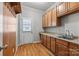 Practical mudroom with cabinets, countertop, sink and access to the backyard at 6424 Chadwell Ct, Fort Mill, SC 29707