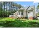 Lush backyard featuring a large deck, garden area, and mature trees at 6990 Ridgeway Rd, Stanley, NC 28164