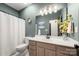 Bathroom featuring a modern vanity, decorative lighting, and stylish neutral accents at 6990 Ridgeway Rd, Stanley, NC 28164