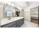 Bathroom featuring a double sink vanity with gold fixtures and a door leading to the primary bedroom at 6990 Ridgeway Rd, Stanley, NC 28164
