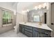 Modern bathroom featuring a double sink vanity with gold fixtures, complemented by a walk-in shower at 6990 Ridgeway Rd, Stanley, NC 28164