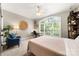 Bedroom with an arched window, cozy chair, carpeted floor, and ample natural light at 6990 Ridgeway Rd, Stanley, NC 28164