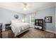 Charming bedroom with light blue walls, a striped bedspread, and a cozy window view at 6990 Ridgeway Rd, Stanley, NC 28164