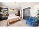 Cozy bedroom features neutral walls, carpeted floor, dark doors, and comfortable blue chair at 6990 Ridgeway Rd, Stanley, NC 28164