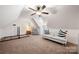 Bonus room features a sofa, pitched ceilings, and a cozy sitting area at 6990 Ridgeway Rd, Stanley, NC 28164
