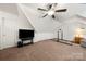 Bonus room featuring pitched ceilings, carpeted floor, a large television, and ample space at 6990 Ridgeway Rd, Stanley, NC 28164
