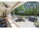 Spacious covered deck featuring outdoor seating, a grill, and ceiling fans for comfortable outdoor living at 6990 Ridgeway Rd, Stanley, NC 28164