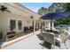 Relaxing covered patio with ample seating, ceiling fans, and access to the lush backyard at 6990 Ridgeway Rd, Stanley, NC 28164