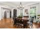Dining room features hardwood floors, a chandelier, and a black front door in view at 6990 Ridgeway Rd, Stanley, NC 28164
