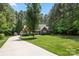Beautifully landscaped home on a large lot with a long driveway and mature trees at 6990 Ridgeway Rd, Stanley, NC 28164