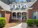 Inviting brick front porch with white columns and a welcoming entrance at 6990 Ridgeway Rd, Stanley, NC 28164