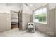 Hallway features stylish neutral walls, marble floor, chair, and a bedroom view through open door at 6990 Ridgeway Rd, Stanley, NC 28164
