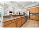 Expansive kitchen featuring generous counter space, stainless appliances, and tile flooring at 6990 Ridgeway Rd, Stanley, NC 28164