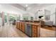 Open-concept kitchen with a large island, stainless steel appliances, and seamless flow to the dining and living areas at 6990 Ridgeway Rd, Stanley, NC 28164