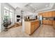 Open kitchen and living room layout with vaulted ceilings and seamless flow at 6990 Ridgeway Rd, Stanley, NC 28164