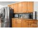 Well-lit kitchen featuring stainless steel appliances and beautiful wood cabinetry and countertop appliances at 6990 Ridgeway Rd, Stanley, NC 28164