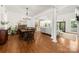 Open-concept living and dining area featuring hardwood floors and bright white columns at 6990 Ridgeway Rd, Stanley, NC 28164