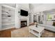 Cozy living room showcasing a fireplace with white mantle and built-in bookshelves at 6990 Ridgeway Rd, Stanley, NC 28164