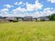 Expansive backyard view features a large grassy area, ideal for outdoor activities and relaxation at 709 Cavesson Way, Monroe, NC 28110