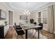 Formal dining room showcasing a modern chandelier, large windows, and elegant decor at 709 Cavesson Way, Monroe, NC 28110