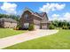 Beautiful brick home featuring an attached two car garage, driveway, and manicured landscaping at 709 Cavesson Way, Monroe, NC 28110