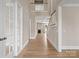 Spacious foyer featuring wood floors, high ceilings, and staircase leading to the second level of the home at 709 Cavesson Way, Monroe, NC 28110
