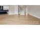 Bright foyer showcasing hardwood floors, a staircase, and views into the adjacent rooms at 709 Cavesson Way, Monroe, NC 28110