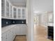 Bright kitchen featuring white cabinets, a sleek countertop, and a stylish blue tile backsplash at 709 Cavesson Way, Monroe, NC 28110