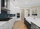 Well-equipped kitchen with stainless steel appliances, white cabinets, and ample counter space at 709 Cavesson Way, Monroe, NC 28110