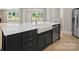 Kitchen island with a farmhouse sink, dishwasher, and stainless steel appliances at 709 Cavesson Way, Monroe, NC 28110