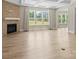 Open living room with a brick fireplace, coffered ceilings, and large windows offering natural light at 709 Cavesson Way, Monroe, NC 28110