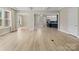 Spacious living room with hardwood floors, offering views into the kitchen and dining areas at 709 Cavesson Way, Monroe, NC 28110