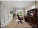 Comfortable office space featuring a large window, wooden desk, and a decorative rug at 709 Cavesson Way, Monroe, NC 28110