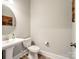 Elegant powder room with a pedestal sink, modern fixtures, and decorative wall art at 709 Cavesson Way, Monroe, NC 28110
