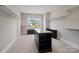 Spacious walk-in closet with custom shelving and a center island for storage and organization at 709 Cavesson Way, Monroe, NC 28110