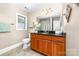 Cozy bathroom features granite countertop, wood cabinets, and a window at 7220 Swansea Ln, Cornelius, NC 28031