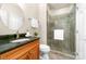 Bathroom with granite countertop and walk-in shower featuring a glass door at 7220 Swansea Ln, Cornelius, NC 28031