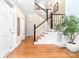 Bright foyer with hardwood floors, staircase, and elegant decor at 7220 Swansea Ln, Cornelius, NC 28031