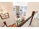 Bright living room features a stone fireplace, hardwood floors, and large windows with waterfront views at 7220 Swansea Ln, Cornelius, NC 28031