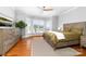 Bedroom with hardwood floors, natural light, and views of the lake at 7220 Swansea Ln, Cornelius, NC 28031