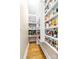 Pantry with shelves stocked with food items, and hardwood floors at 7220 Swansea Ln, Cornelius, NC 28031