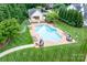 Aerial view of community pool with lounge chairs and manicured lawn at 7220 Swansea Ln, Cornelius, NC 28031